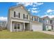 Charming two-story home features a light gray exterior, well-kept lawn, and attached two car garage at 231 Hayworth Rd, Summerville, SC 29486