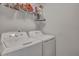 Bright laundry room featuring a white washer and dryer set and convenient overhead shelving at 231 Hayworth Rd, Summerville, SC 29486