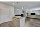 Open living room featuring island with granite countertops, stainless steel appliances, and hardwood floors at 231 Hayworth Rd, Summerville, SC 29486
