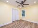 Bedroom with wood-look floors, fan, closet, and natural light at 2647 Tillman St, North Charleston, SC 29405
