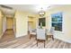 Sunny dining room with wood floors and a modern chandelier, perfect for Gathering meals and entertaining guests at 2647 Tillman St, North Charleston, SC 29405