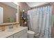 Bathroom with a neutral color palette features a vanity, mirror, and a shower with a leafy shower curtain at 2900 Colonnade Dr, Mount Pleasant, SC 29466
