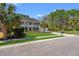 Two-story home with a double-decker porch, manicured lawn, and mature trees at 2900 Colonnade Dr, Mount Pleasant, SC 29466