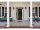 Inviting front porch with white columns, outdoor seating, and stylish lighting at 2900 Colonnade Dr, Mount Pleasant, SC 29466