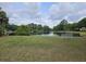 Scenic pond view with lush greenery and bench, perfect for relaxation at 2900 Colonnade Dr, Mount Pleasant, SC 29466