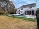 Backyard oasis with a sparkling pool, poolside lounge chairs, an outdoor table, and a manicured lawn at 2900 Colonnade Dr, Mount Pleasant, SC 29466