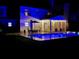 Nighttime view of a backyard with a swimming pool, lounge chairs, an outdoor table, and a screened-in porch at 2900 Colonnade Dr, Mount Pleasant, SC 29466
