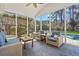 Screened-in porch offers outdoor seating, fan, and a view of the pool and garden at 2900 Colonnade Dr, Mount Pleasant, SC 29466