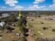 Stunning aerial view of estate featuring lush green pastures, mature trees and serene lakes under a blue sky at 3019 Eventide Dr, Johns Island, SC 29455