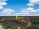 Captivating aerial view of lakeside property surrounded by mature trees under a blue sky with picturesque cloud formations at 3019 Eventide Dr, Johns Island, SC 29455