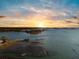 Scenic sunset aerial view of a waterway with a dock stretching into the water at 3019 Eventide Dr, Johns Island, SC 29455
