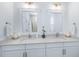 Bathroom featuring a double vanity with framed mirrors, and white cabinets at 3019 Eventide Dr, Johns Island, SC 29455