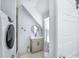 Charming bathroom with stylish vanity, neutral color scheme, modern fixtures, and stackable laundry at 3019 Eventide Dr, Johns Island, SC 29455