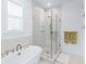 Modern bathroom featuring a glass-enclosed shower, soaking tub, and marble wall and floor tile at 3019 Eventide Dr, Johns Island, SC 29455