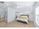 Bright bedroom featuring light wood floors, ensuite bath, and a neutral color palette at 3019 Eventide Dr, Johns Island, SC 29455