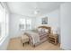 Bedroom with a wicker headboard, plaid accents, hardwood floors, and bright natural light at 3019 Eventide Dr, Johns Island, SC 29455