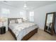 Bedroom featuring a large bed, cozy comforter, ceiling fan and decorative mirror at 3019 Eventide Dr, Johns Island, SC 29455