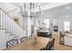Bright dining room with wood table, black chairs, statement lighting, and open access to the kitchen at 3019 Eventide Dr, Johns Island, SC 29455