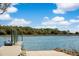 Scenic dock by the water with blue skies and lush greenery in the background for boating enthusiasts at 3019 Eventide Dr, Johns Island, SC 29455