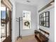 Bright entryway features a rustic wooden bench and coat rack, creating a welcoming space at 3019 Eventide Dr, Johns Island, SC 29455