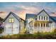 Charming two-story home with a welcoming front porch and a separate garage under a colorful dusk sky at 3019 Eventide Dr, Johns Island, SC 29455