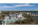 Luxurious resort-style community featuring a pool, sun loungers, and stunning waterfront views, under a blue sky at 3019 Eventide Dr, Johns Island, SC 29455