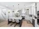 Modern kitchen with marble island, stainless appliances, white cabinets, and stylish pendant lighting at 3019 Eventide Dr, Johns Island, SC 29455