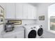 Bright laundry room features built-in storage and modern washer and dryer units at 3019 Eventide Dr, Johns Island, SC 29455