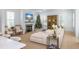 Cozy living room with fireplace, white sectional, neutral tones and an antique cabinet at 3019 Eventide Dr, Johns Island, SC 29455