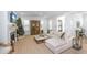 Bright living room with white sectional sofa, fireplace and view of the antique hutch at 3019 Eventide Dr, Johns Island, SC 29455