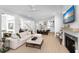 Spacious living room with white sectional, fireplace, open to modern kitchen and dining area at 3019 Eventide Dr, Johns Island, SC 29455