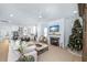 Bright living room with a cozy fireplace, open kitchen and a view of the Christmas tree at 3019 Eventide Dr, Johns Island, SC 29455