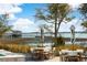 Relaxing outdoor seating area with tables and chairs, offering picturesque views of the waterfront and dock at 3019 Eventide Dr, Johns Island, SC 29455