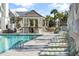 Relaxing poolside featuring a bar and comfortable lounge chairs under sun umbrellas, perfect for leisure at 3019 Eventide Dr, Johns Island, SC 29455