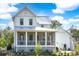 The rear exterior shows a charming screened porch and metal roof under a bright sky at 3019 Eventide Dr, Johns Island, SC 29455