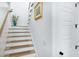 Elegant staircase with wood treads, white risers, and decorative accents at 3019 Eventide Dr, Johns Island, SC 29455