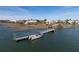 Scenic waterfront community with a boat dock, lush trees, and beautiful waterfront homes under a blue sky at 3019 Eventide Dr, Johns Island, SC 29455