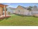 Spacious backyard with green grass, a patio area, and a detached garage at 303 Crossandra Ave, Summerville, SC 29483