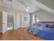 Bedroom showcasing hardwood flooring, ceiling fan, natural light and closet at 303 Crossandra Ave, Summerville, SC 29483