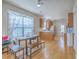 Bright dining area with hardwood floors and a view into the kitchen, offering a modern and airy feel at 303 Crossandra Ave, Summerville, SC 29483