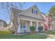 Charming two-story home featuring a cozy front porch with white columns and meticulously maintained landscaping at 303 Crossandra Ave, Summerville, SC 29483