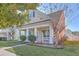 Two-story home with a charming front porch and well-maintained landscaping at 303 Crossandra Ave, Summerville, SC 29483