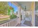 Cozy front porch with hanging plants and serene neighborhood views at 303 Crossandra Ave, Summerville, SC 29483