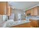 Bright kitchen with wood cabinets, white countertops and stainless steel appliances at 303 Crossandra Ave, Summerville, SC 29483