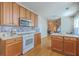 Updated kitchen showcasing wood cabinets and countertops, tile backsplash, and modern appliances at 303 Crossandra Ave, Summerville, SC 29483