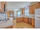 Spacious kitchen with wood cabinets, white countertops, hardwood flooring, and modern appliances at 303 Crossandra Ave, Summerville, SC 29483