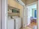 Laundry area featuring washer, dryer, and shelving for storage at 303 Crossandra Ave, Summerville, SC 29483