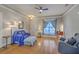 Bright living room with hardwood floors, a ceiling fan, comfortable seating, and ample natural light at 303 Crossandra Ave, Summerville, SC 29483
