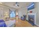 Bright living room with hardwood floors, a fireplace, comfortable seating, and ample natural light at 303 Crossandra Ave, Summerville, SC 29483