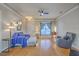 Bright living room with hardwood floors, a ceiling fan, comfortable seating, and ample natural light at 303 Crossandra Ave, Summerville, SC 29483